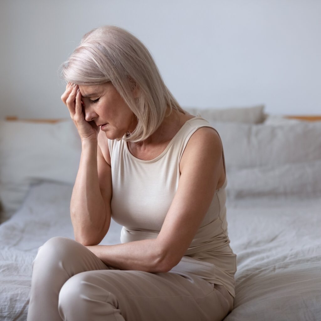 older woman experiencing menopause symptoms